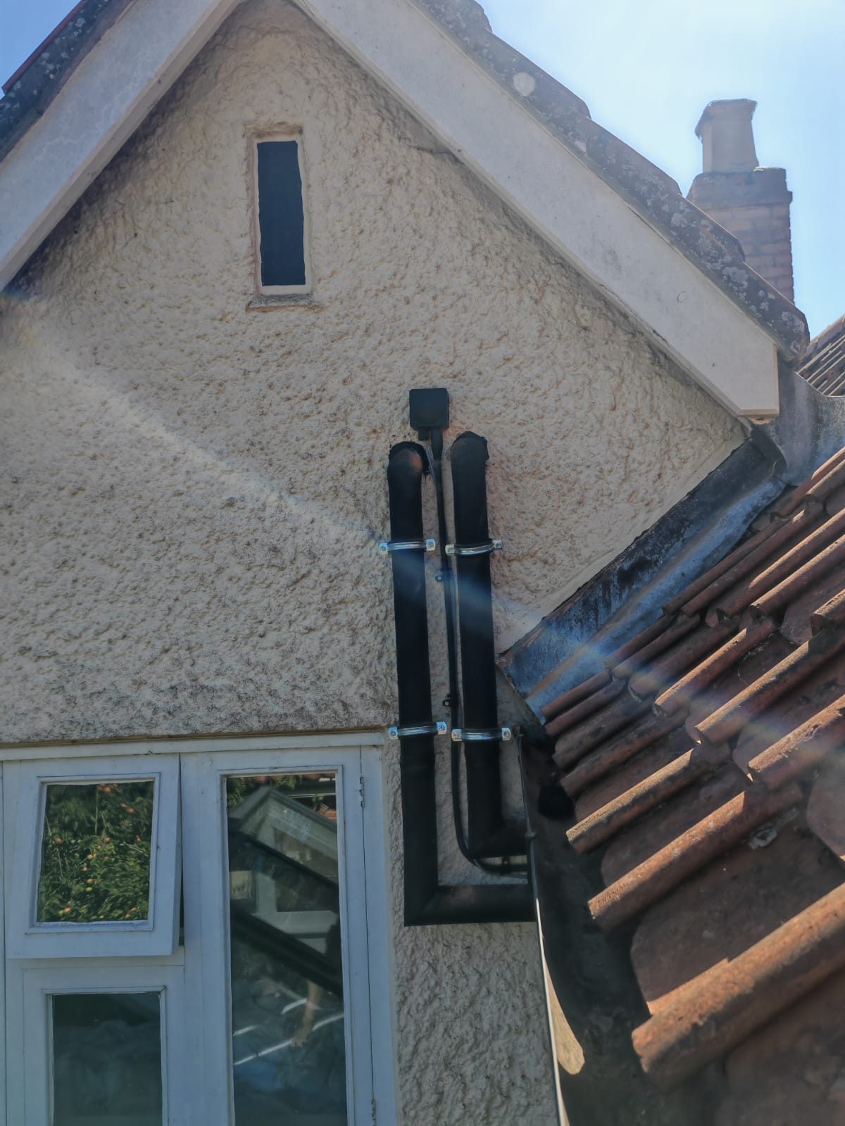 New pipework run neatly up the gable. Whole house air source heat pump by FB Gas, photo 03