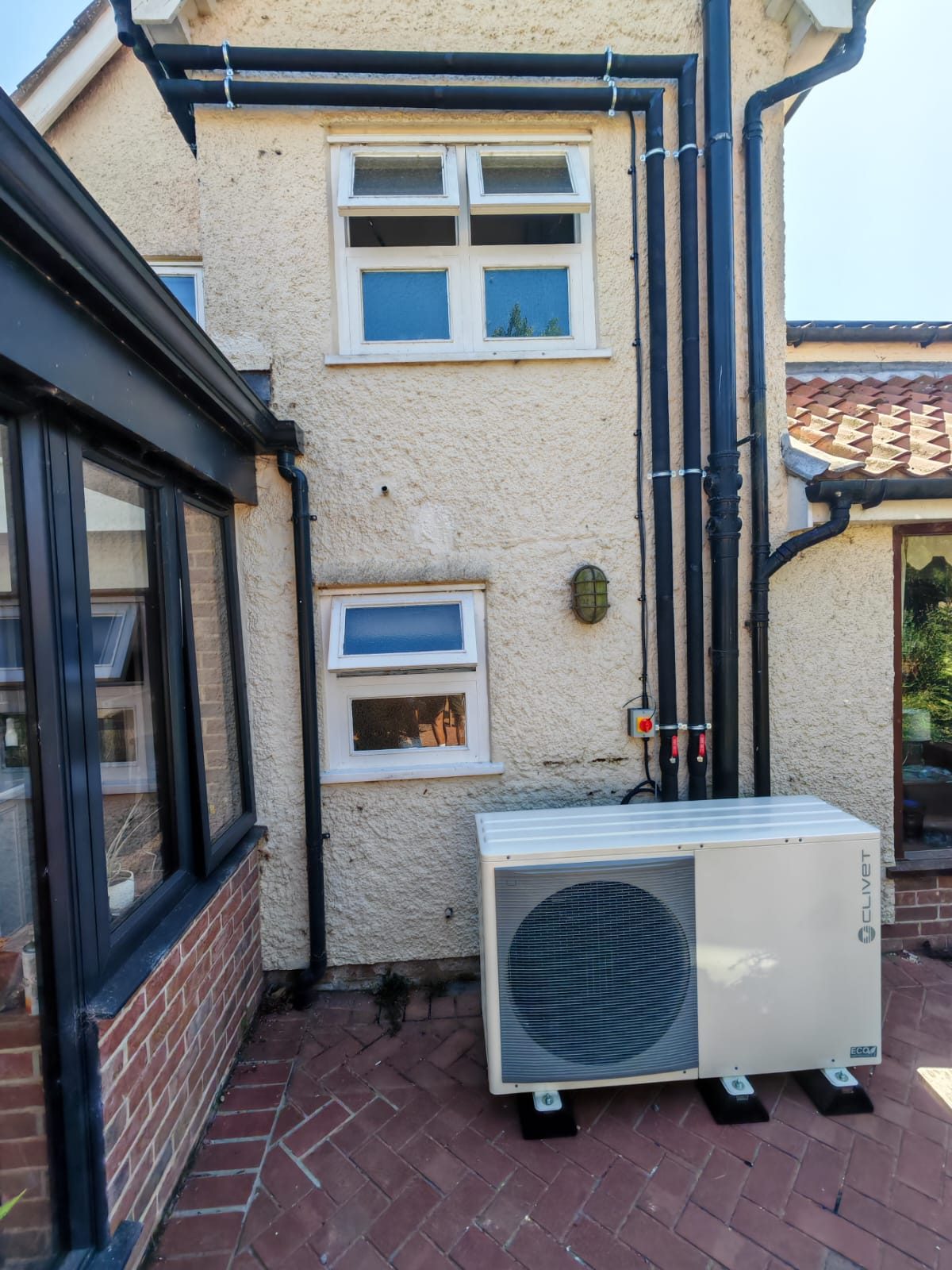 The unit sat clear of the doors and paths. Whole house air source heat pump by FB Gas, photo 07