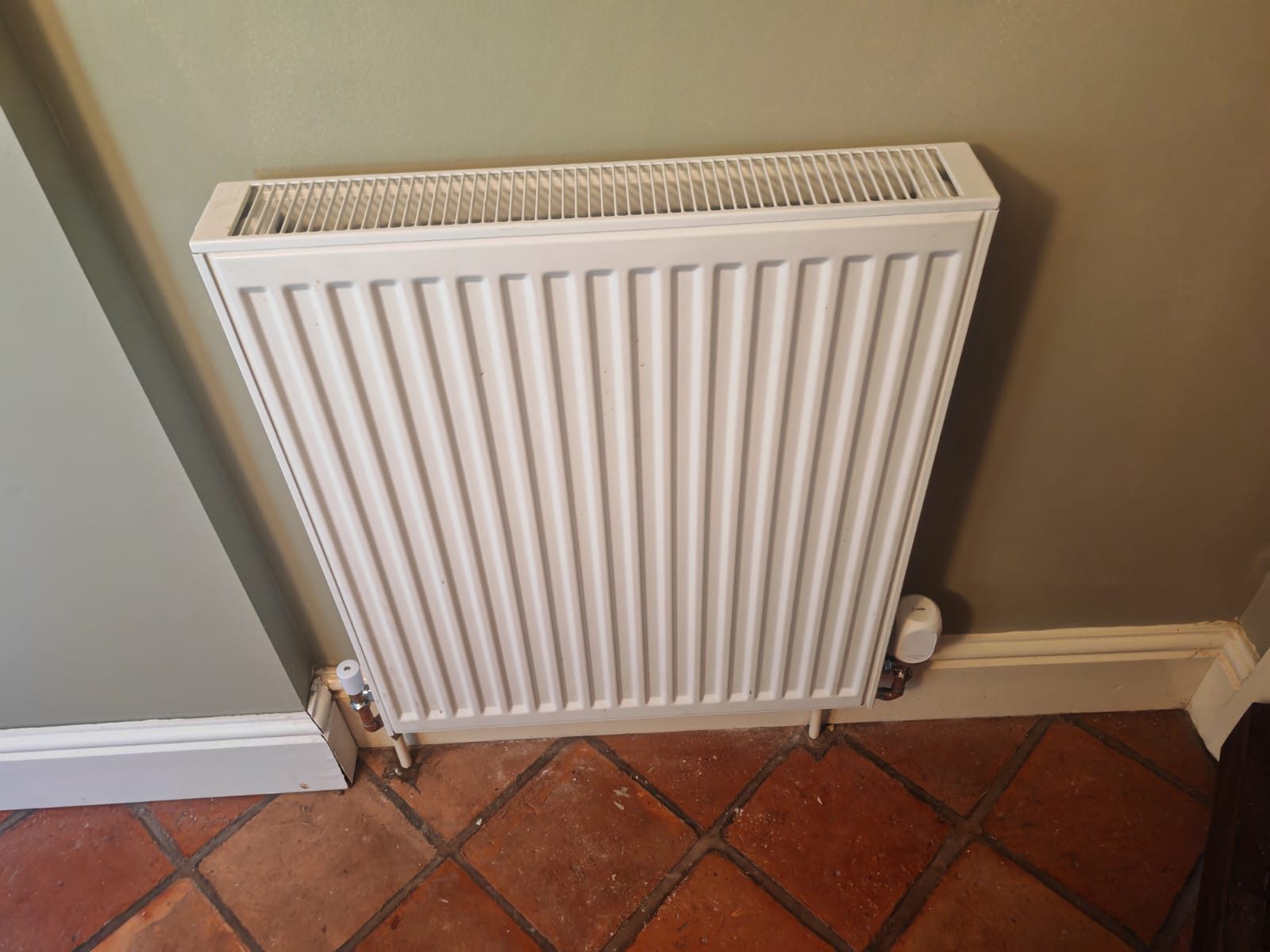New radiator on a quarry tiled floor. Whole house air source heat pump by FB Gas, photo 12