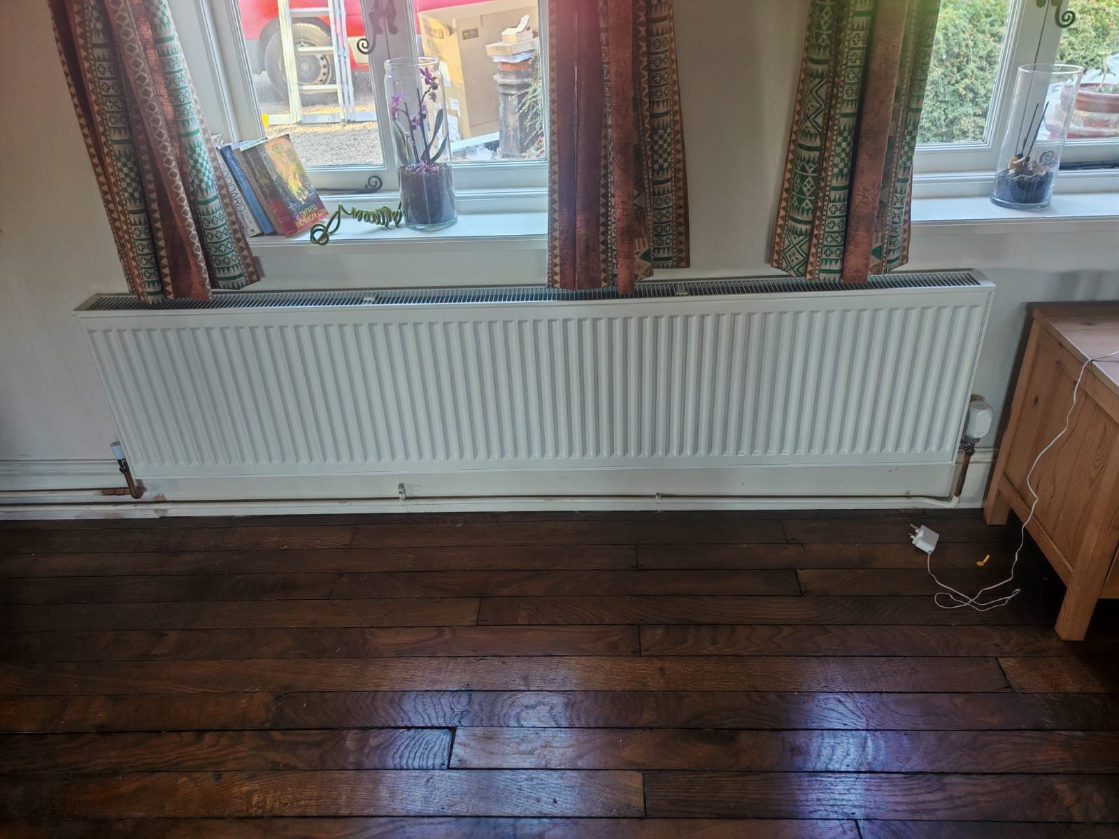 Long radiator under the window on dark boards. Whole house air source heat pump by FB Gas, photo 14
