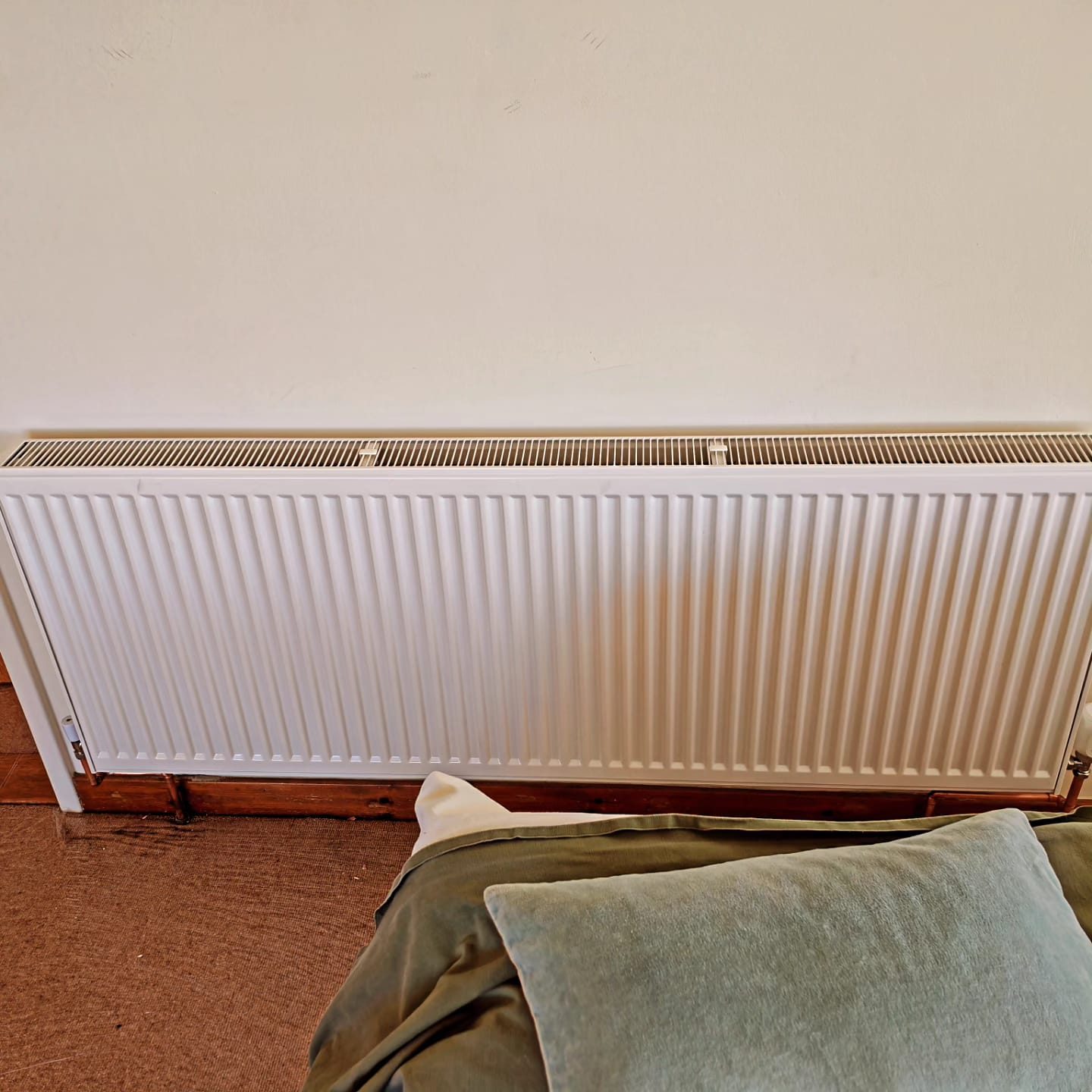 Long panel radiator installed and levelled