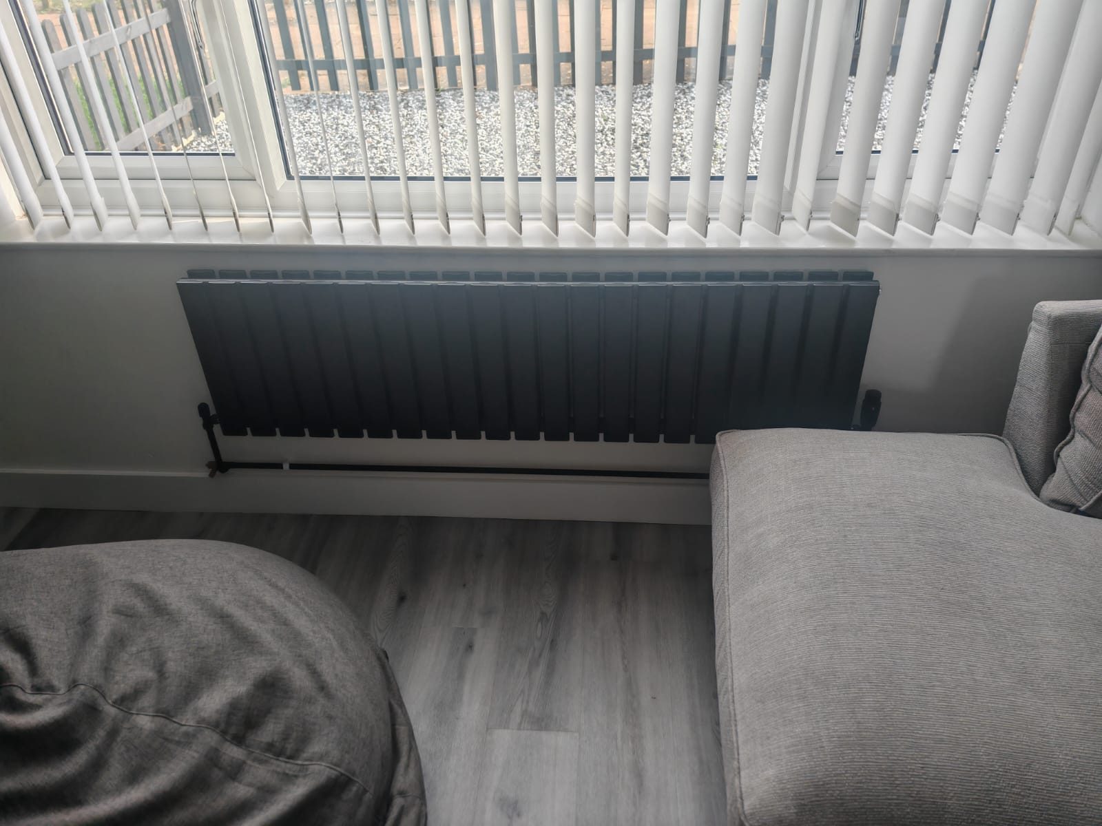 Anthracite horizontal radiator fitted neatly under a window
